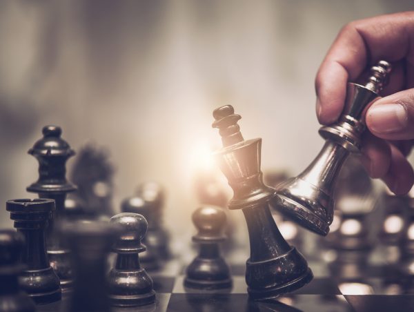 Hand,Of,Businessman,Moving,Chess,Figure,In,Competition,Success,Play.